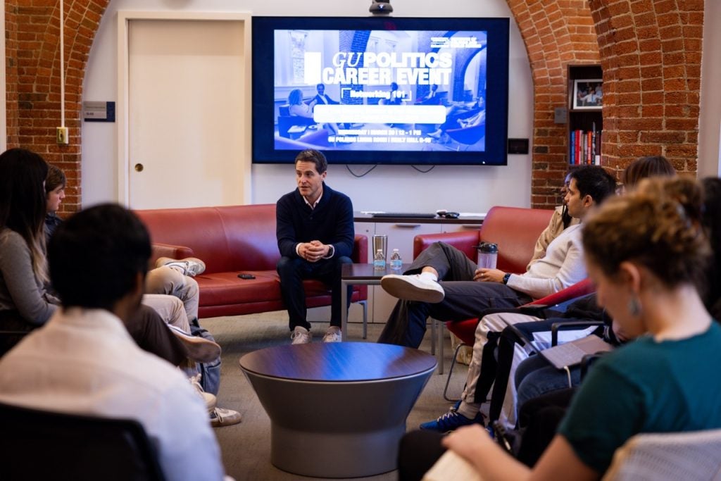 Manatos speaks to students in the Living Room.