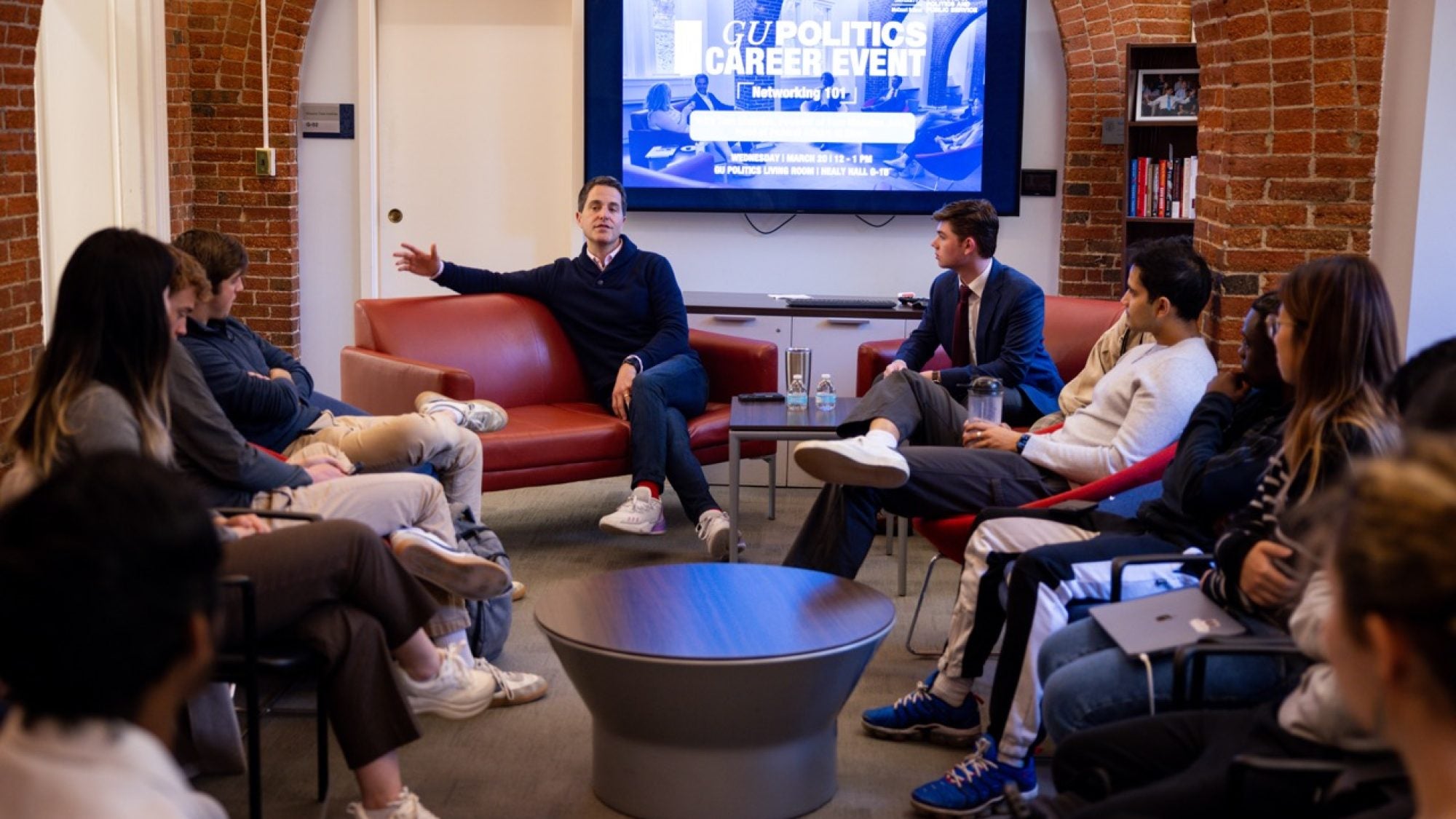 Manatos speaks to students in the Living Room.