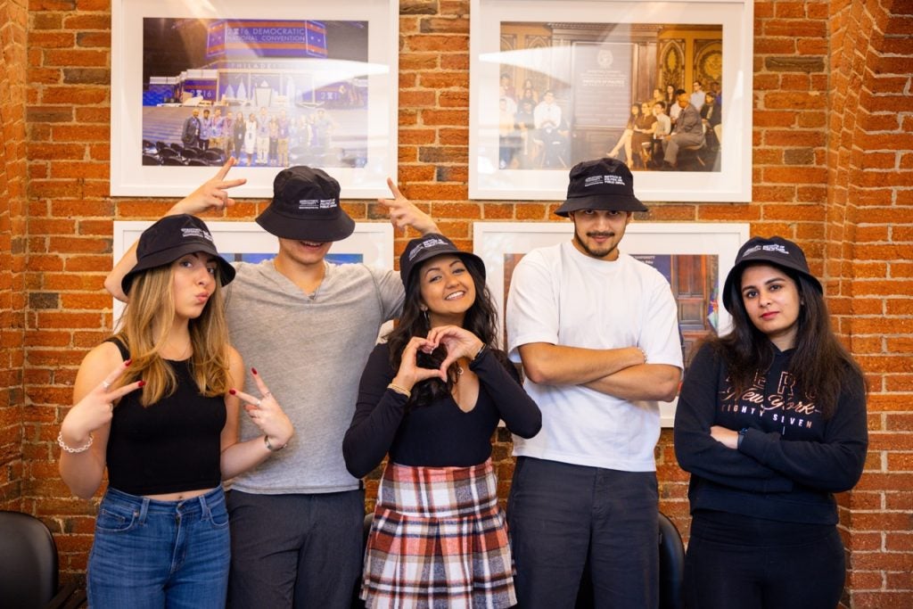 Members of the 2023-2024 Student Advisory Board take a silly photo with GU Politics bucket hats.