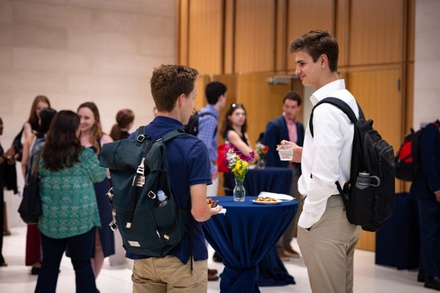 Students and staff mingle at the reception following the event. 