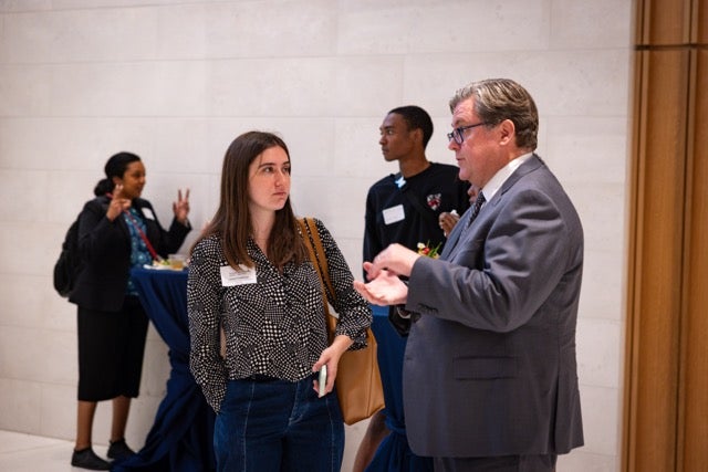 Students and staff mingle at the reception following the event. 