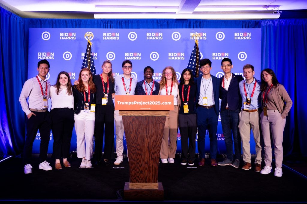 Students posing on stage following DNC press conference