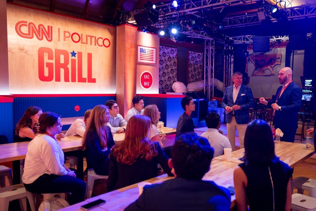 Students talking with Mike Dubke and Matt Gorman at CNN-Politico Grill