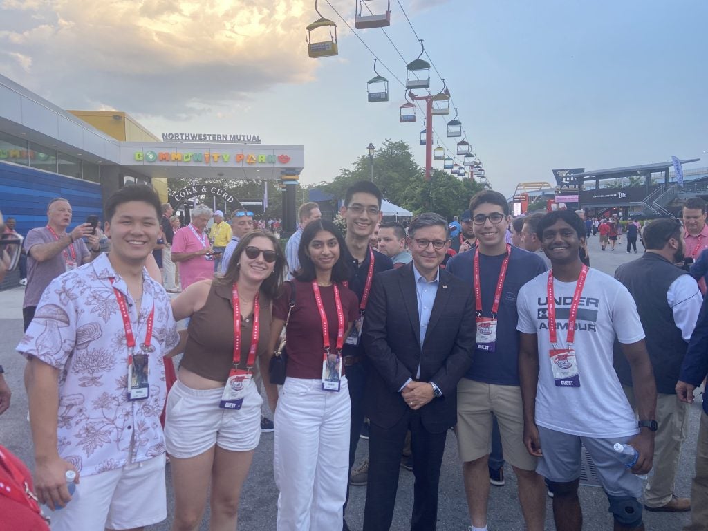 Students smiling and posing with Speaker Mike Johnson.