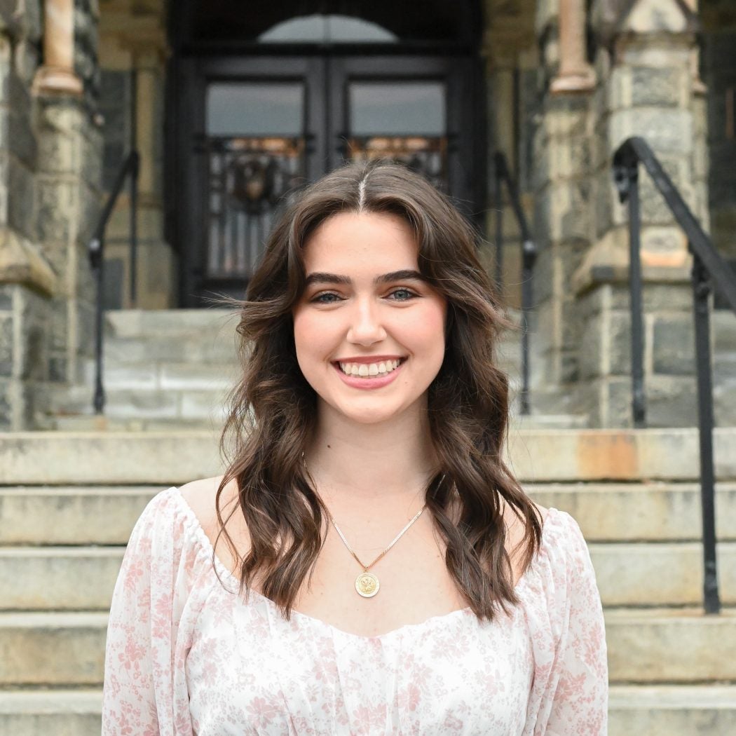 photo of Catherine Hughes in front of Healy Hall