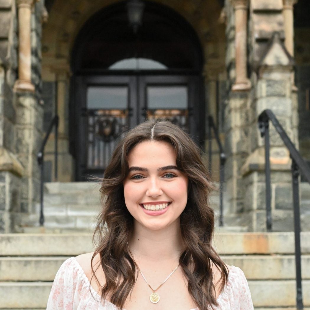 photo of Catherine Hughes in front of Healy Hall