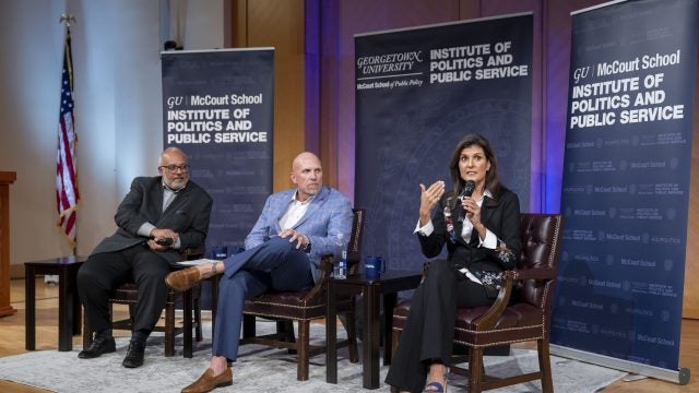 Mo Elleithee, Rick Wiley and Nikki Haley on stage.