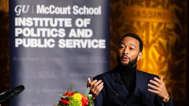 Photo of John Legend speaking while seated