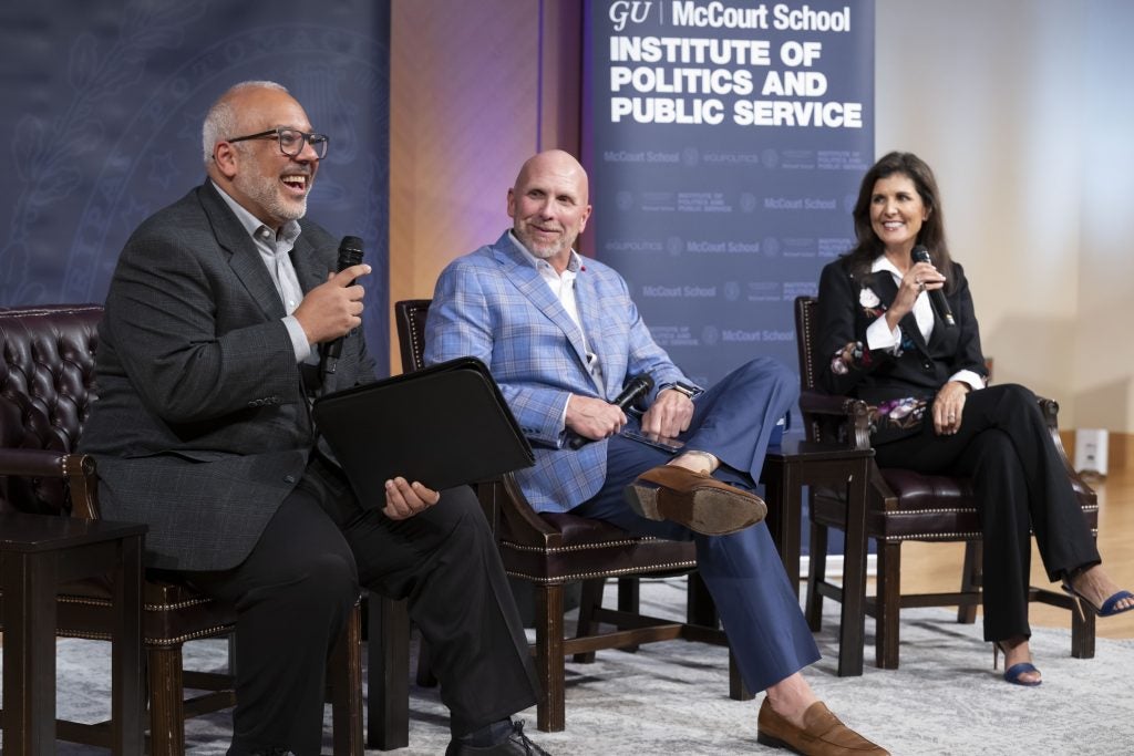 Mo Elleithee, Rick Wiley and Nikki Haley on stage