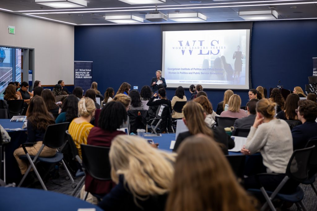 Emily Lampkin presents a workshop from her Women Leaders Series at the front of the room.