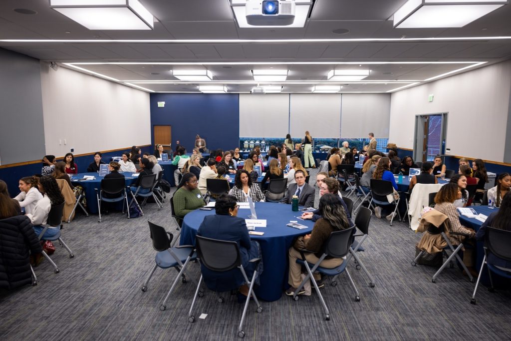 Overhead shot of all the tables and participants conversing.