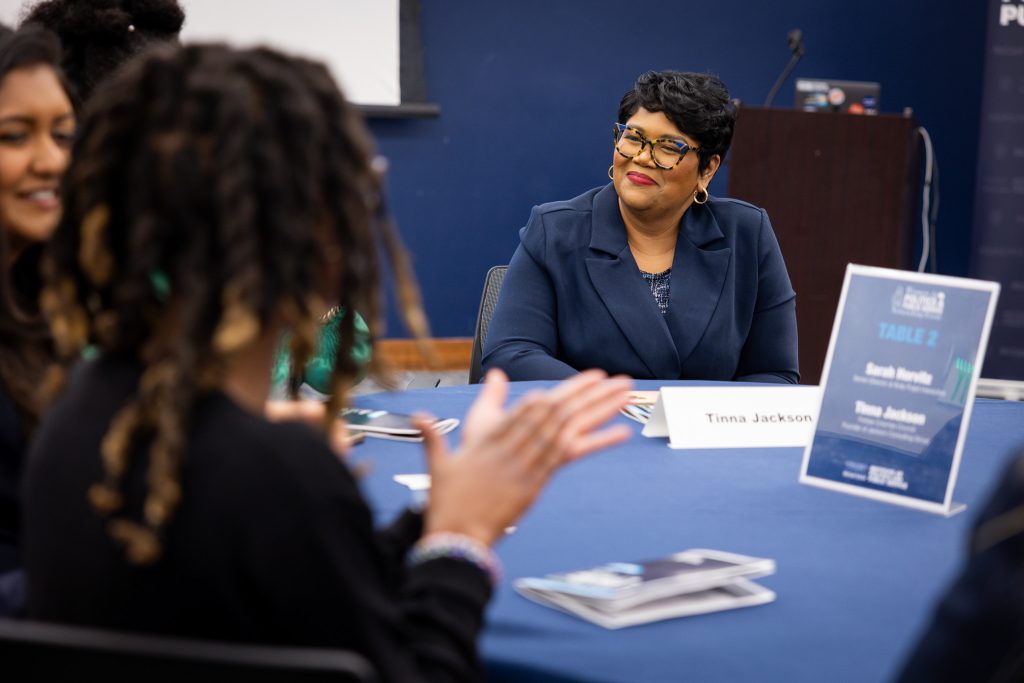 Tinna Jackson smiles and looks at a student as they speak.