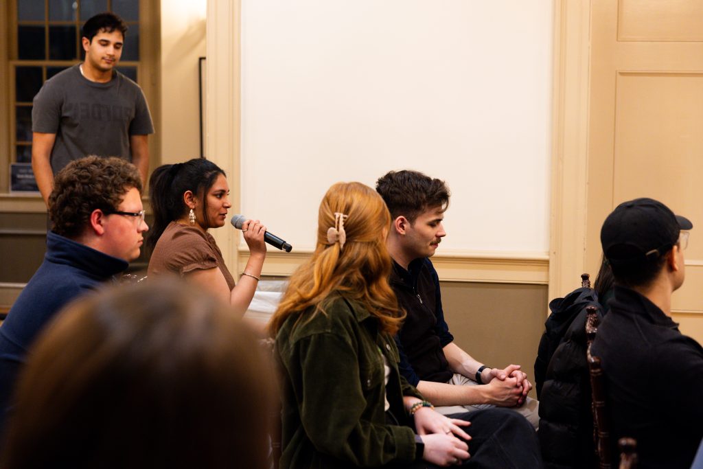 A student asks a question from the audience.