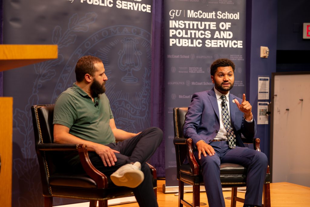 Frost and Lowery speak on stage as Frost gestures.