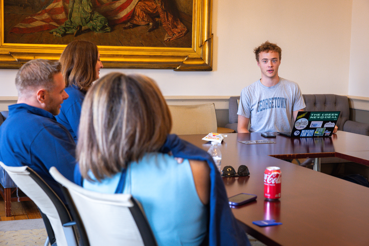 Student sits in front of laptop and interviews Fellows in Old North.