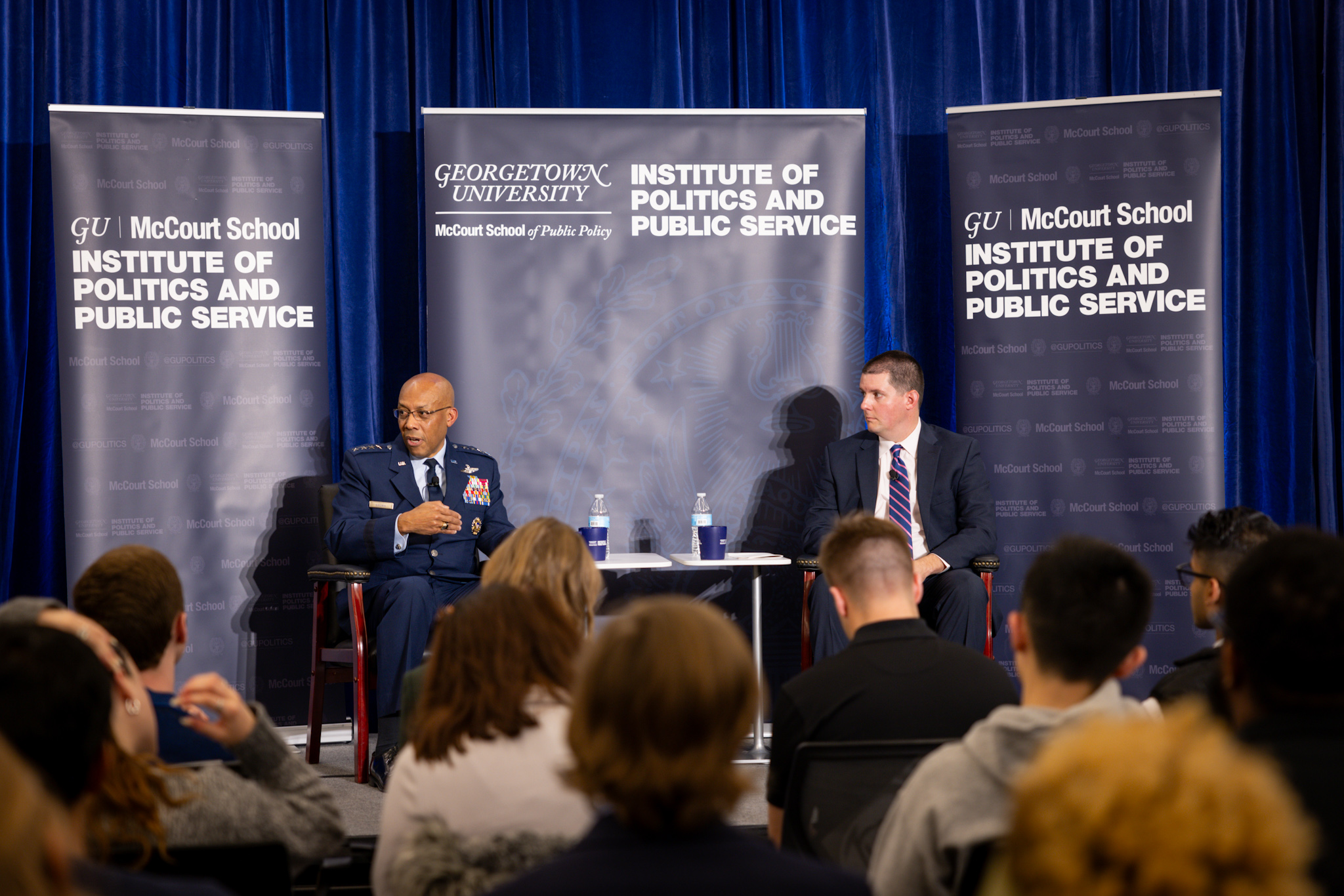 General Brown speaks while Lamothe and audience members listen.