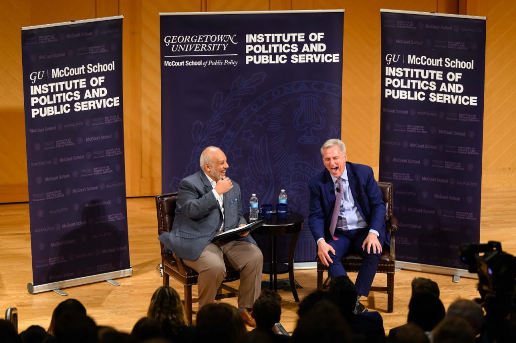 McCarthy and Elleithee laughing on stage.