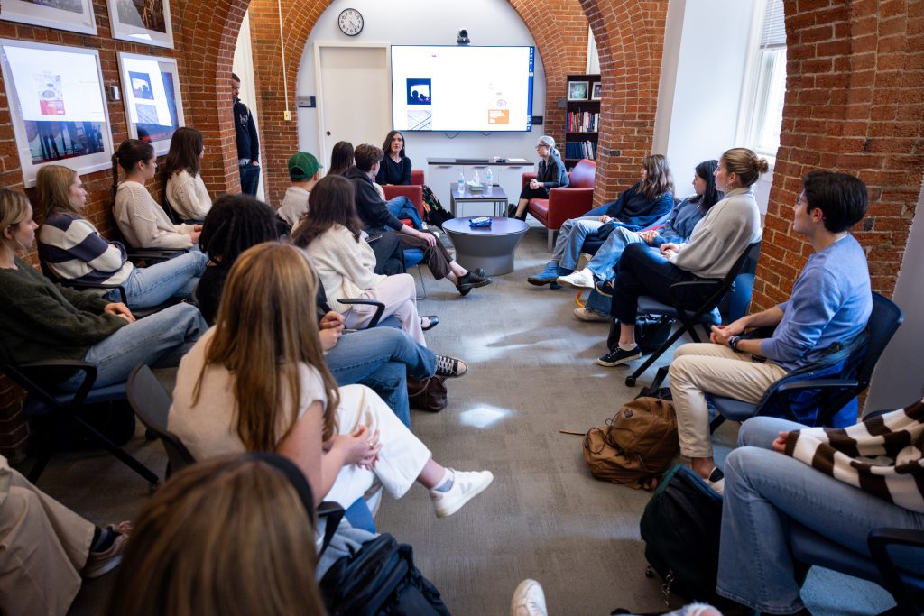 Living Room full of students listening as Kirkland speaks.