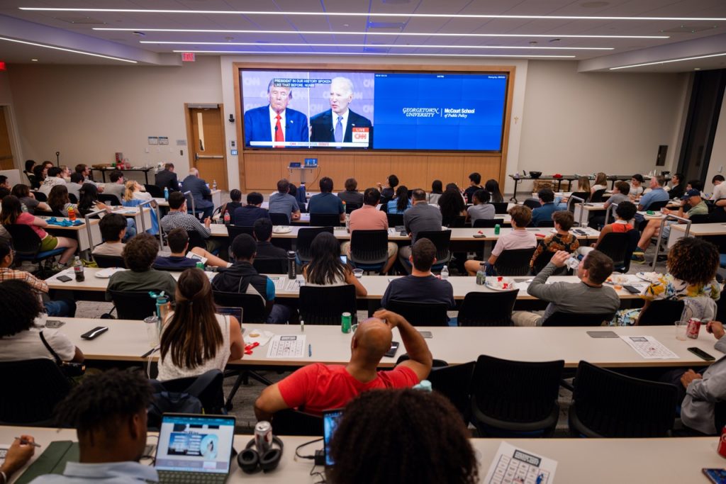 Overhead shot of students watching the debate.