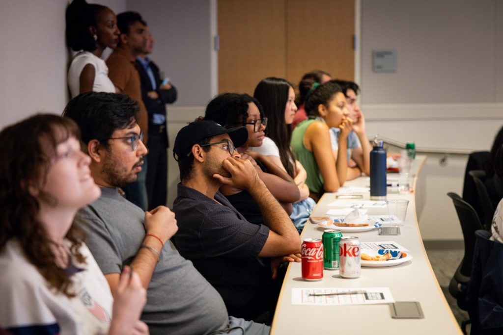 A row of students watch tensely.