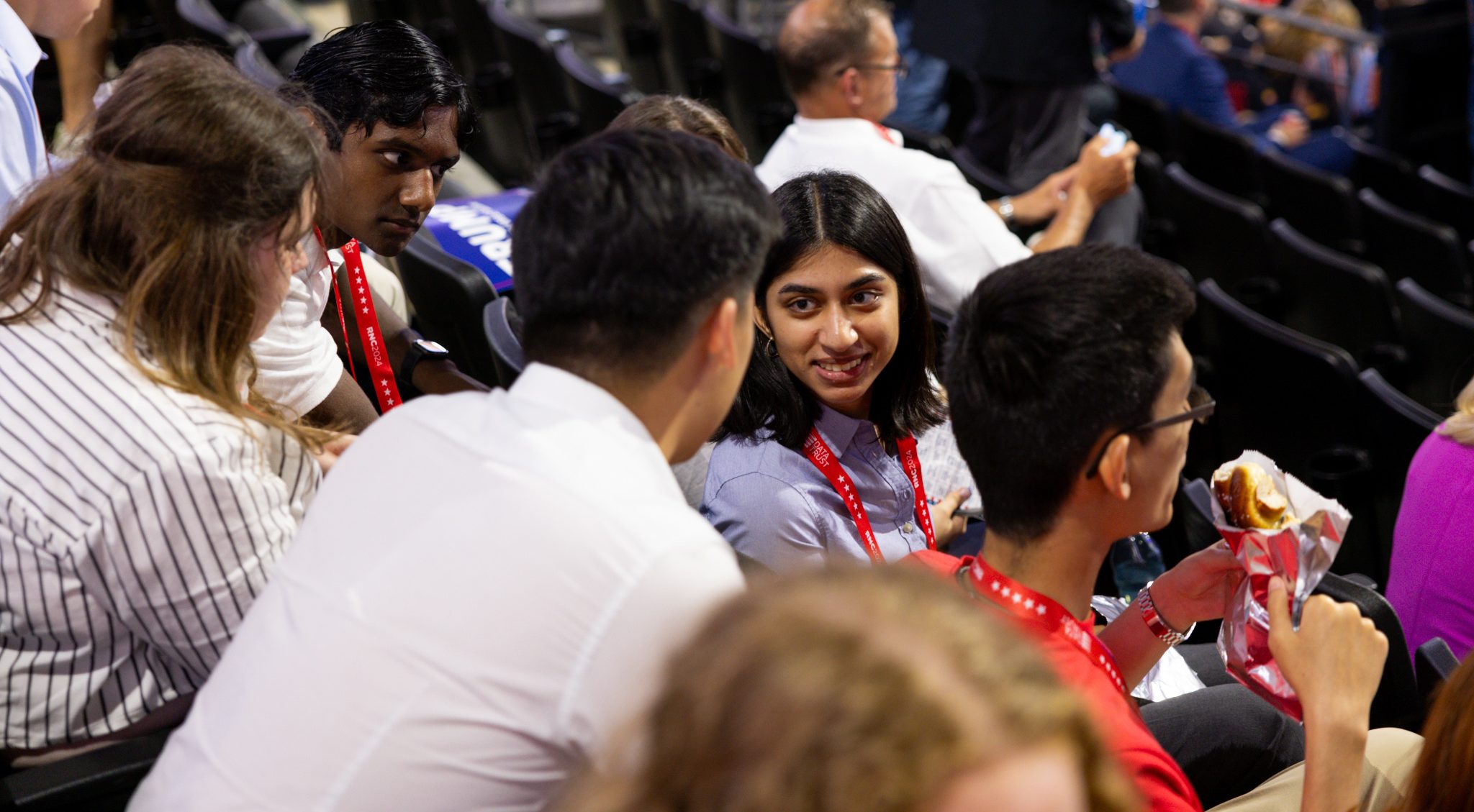 Students excitedly talking to each other in the convention hall.